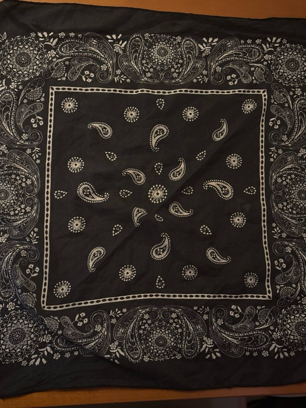 Black bandana with white paisley and floral design